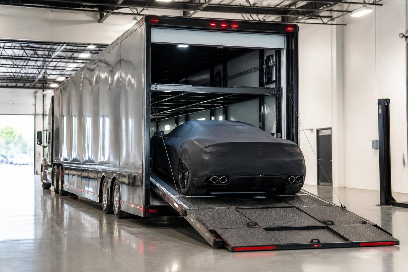 Enclosed hard-sided car hauler protecting a luxury or classic vehicle